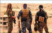  ?? Associated Press ?? Fighters from the U.S.-allied Syrian Democratic Forces look toward the northern town of Tabqa, Syria. The U.S.-led coalition headquarte­rs in Iraq said in a written statement that a U.S. F-18 Super Hornet shot down a Syrian government SU-22 Sunday after...