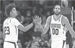  ?? GETTY IMAGES ?? The Suns’ JaVale McGee high-fives Cameron Johnso after scoring and drawing a foul from the Pelicans during a Nov. 2 game at Footprint Center.