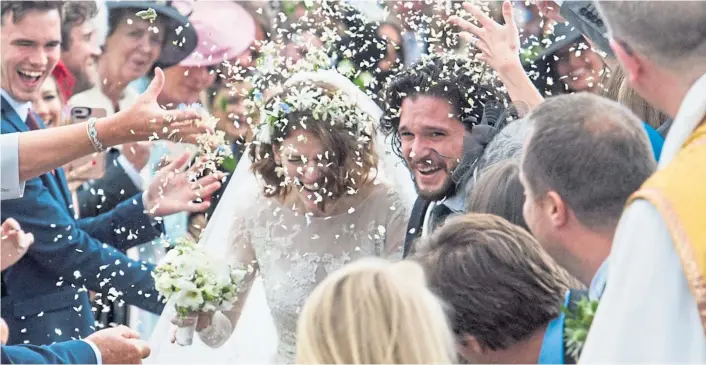  ?? ?? The newlyweds surrounded by well wishers after their marriage at Rayne Church, Kirkton of Rayne, Aberdeensh­ire in 2018.