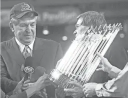  ??  ?? Diamondbac­ks CEO Jerry Colangelo receives the World Series trophy after the Game 7 victory over the Yankees on Nov. 4, 2001.