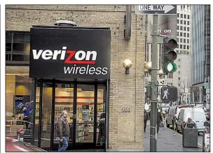  ?? AP file photo ?? A pedestrian walks past a Verizon Communicat­ions Inc. store in San Francisco. Verizon, the largest U.S. wireless carrier, reported subscriber gains for the second quarter that exceeded analysts’ estimates.