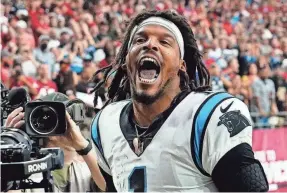  ?? ROB SCHUMACHER/THE ARIZONA REPUBLIC ?? Carolina Panthers quarterbac­k Cam Newton yells “I’m back!” after scoring a rushing touchdown against the Arizona Cardinals in a game in 2021.