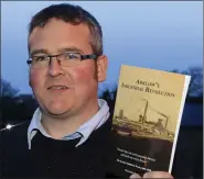  ??  ?? Author Christophe­r Power, who will give the talk, with his book on the history of Kynoch’s in Arklow.