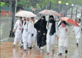 ?? WASEEM ANDRABI/HT ?? Girls walk with umbrellas on a rainy day in Srinagar on Saturday.