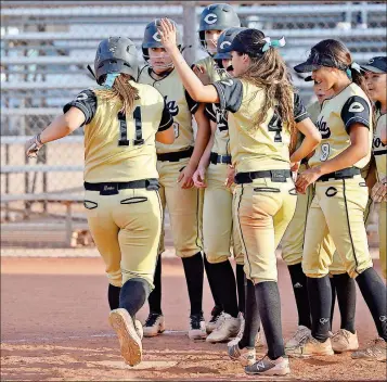  ?? Buy these photos at YumaSun.com PHOTOS BY RANDY HOEFT/YUMA SUN ?? ANGELA OROS’ TEAMMATES GATHER AT HOME PLATE to welcome Oros (11) home after she hit a three-run home run during an April 13 game against Kofa at Cibola. The Raiders received the No. 4 seed in the 6A State Tournament, and will open with a firstround...