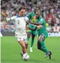  ?? FRANK AUGSTEIN/AP ?? England’s Jack Grealish, left, is challenged by Senegal’s Youssouf Sabali during a World Cup round of 16 match Sunday at the Al Bayt Stadium in Al Khor, Qatar. England won 3-0.