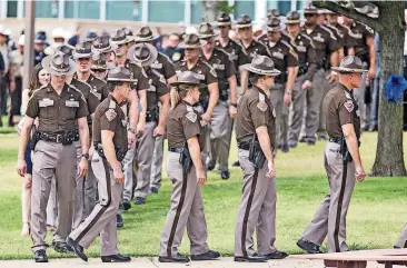  ?? [PHOTO BY CHRIS LANDSBERGE­R, THE OKLAHOMAN] ?? Members of the Oklahoma Highway Patrol file into Lloyd Noble Center during funeral services for Oklahoma Highway Patrol Lt. Donald Heath Meyer.