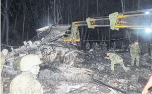  ?? AFP ?? Philippine military personnel inspect the wreckage of the ill-fated Philippine Airforce C-130 transport that crashed near the airport in Jolo town, Sulu province, in the southern island of Mindanao, during search and retrieval operations, on Sunday.