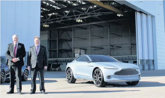  ??  ?? > First Minister Carwyn Jones and Aston Martin chief executive Dr Andy Palmer at St Athan, where Aston Martin is to build its new luxury car, the DBX