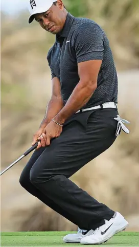  ?? GETTY IMAGES ?? Looking good: Woods watches his putt at the second