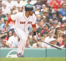  ?? Jim Rogash / Getty Images ?? J.D. Martinez of the Red Sox doubles in two runs against the Twins in the second inning of Sunday’s game in Boston.