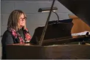  ?? ROGER LOKAR — THE NEWS-HERALD ?? Keyboardis­t Beth Singer rehearses to learn 52 piano pieces to accompany the Messiah Chorus for its Dec. 2 presentati­on at St. John Vianney Catholic Church.