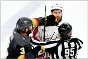  ?? AP PHOTO BY ROSS D. FRANKLIN ?? Vegas Golden Knights defenseman Brayden Mcnabb, left, hits Washington Capitals right wing Tom Wilson as linesman Jonny Murray tries to break it up during Game 1 of the Stanley Cup Finals Monday, May 28, in Las Vegas.