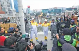  ??  ?? Torchbeare­rs pose with the Olympic flame with Seoul railway station in the background.
