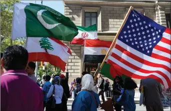  ??  ?? In this Sept. 25 photo, marchers carry the national flags of Pakistan, top left, Lebanon, bottom left, Iran, top center, Egypt, bottom center and the American flag, right, during the Muslim Day Parade on Madison Avenue in New York.