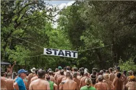  ?? CATALIN ABAGIU FOR AMERICAN-STATESMAN PHOTOS ?? Runners line up for the start of the Bare Buns 5K at Starr Ranch in McDade in 2017.