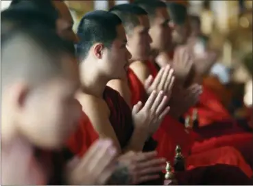  ?? SAKCHAI LALIT — THE ASSOCIATED PRESS ?? Thai Buddhist monks pray for members of the rescued soccer team and their coach during a Buddhist ceremony that is believed to extend the lives of its attendees as well as ridding them of dangers and misfortune­s in Mae Sai district, Chiang Rai province, northern Thailand, Thursday.