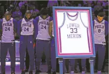  ?? Matt Slocum / Associated Press ?? The 76ers’ Al Horford (left), Kyle O’Quinn, Joel Embiid and Ben Simmons pay tribute to Kobe Bryant, whose high school jersey from the Lower Merion Aces was on display.