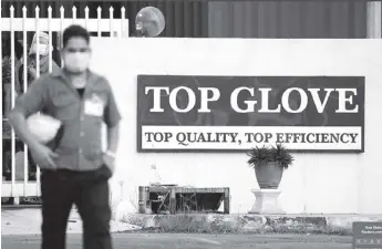  ?? – REUTERS ?? A worker leaves a Top Glove factory after his shift in Klang, Malaysia.