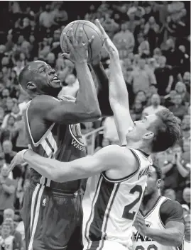  ?? GEORGE FREY/GETTY IMAGES ?? Draymond Green, who totaled 20 points, shoots over Gordon Hayward of the Jazz.