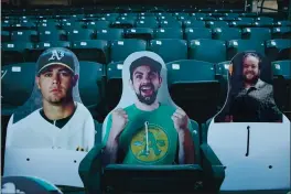  ?? JANE TYSKA — STAFF PHOTOGRAPH­ER ?? Cutouts representi­ng fans are seen at the Oakland Coliseum during the exhibition game between the Giants and A’s on Monday night.