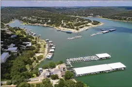  ??  ?? Marinas like these on the Cypress Creek Arm of Lake Travis will play a key role in reducing the spread of zebra mussels. The risk now is that zebra mussels could infest other lakes via recreation­al gear traveling from Lake Travis or other infested...