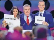  ?? AFP ?? IOC chief Thomas Bach (centre) with Paris Mayor Anne Hidalgo and Los Angeles Mayor Eric Garcetti at the IOC session in Lima.