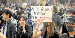  ?? —REUTERS ?? A woman holds a sign during the “Lest We Forget” rally in Kowloon in Hong Kong on Sunday.