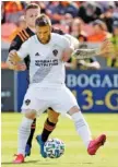  ?? AP PHOTO/MICHAEL WYKE ?? Los Angeles Galaxy midfielder Aleksandar Katai, front, shields the ball from Houston Dynamo defender Adam Lundkvist during a Feb. 29 match in Houston.