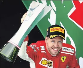  ?? MARK THOMPSON GETTY IMAGES ?? Sebastian Vettel of Germany and Ferrari celebrates on the podium after the Canadian Formula One Grand Prix at Circuit Gilles Villeneuve in Montreal on Sunday.