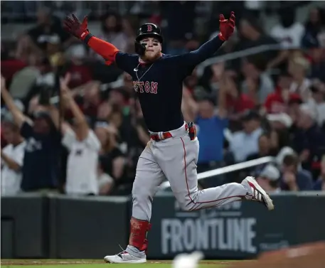  ?? Ap pHotos ?? IN THE CLUTCH: Alex Verdugo celebrates his go-ahead three-run home run during the eighth inning on Tuesday night in Atlanta, Ga. Below, Rafael Devers delivers an RBI single in the third inning.