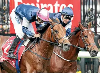  ?? PHOTOS: GETTY IMAGES ?? Rekindling, ridden by Corey Brown (left) wears down Johannes Vermeer (Ben Melham) in the closing stages of the Melbourne Cup yesterday.