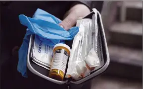  ?? CP PHOTO JONATHAN HAYWARD ?? A naloxone anti-overdose kit is shown in Vancouver, Friday, Feb. 10, 2017. Toronto is speeding up the opening of three supervised injection sites and asking local police to consider having some officers carry the opioid overdose antidote naloxone as...