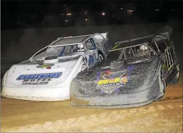  ?? PHOTOS BY RICH KEPNER - FOR DIGITAL FIRST MEDIA ?? Austin Hubbard (11) and David Pettyjohn (8) trade paint during the Late Model feature at Georgetown, Del., on Oct. 28.