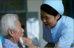  ?? PROVIDED TO CHINA DAILY ?? A nurse takes care of an elderly patient at a Kangning Hospital in Ningbo, Zhejiang province. The hospital belongs to the largest private psychiatri­c healthcare group in China.