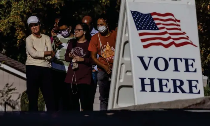  ?? Photograph: Carlos Barría/Reuters ?? Residents wait in line to cast their ballots during early voting in Mableton, Georgia, on 4 November.