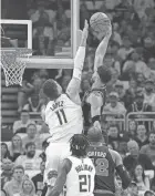  ?? MICHAEL MCLOONE/USA TODAY SPORTS ?? The Celtics’ Jayson Tatum, top right, dunks over the Bucks’ Brook Lopez, top left, Monday in Milwaukee.