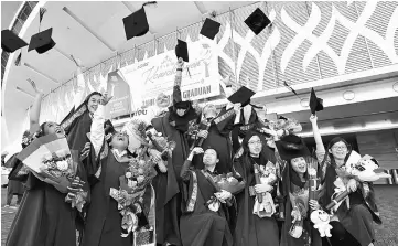  ??  ?? Graduates jubilate after their graduation. — Bernama photo