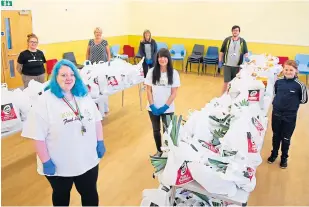  ??  ?? Volunteers at the new St Mary’s foodbank.