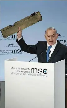  ?? Lennart Preiss/MSC/dpa/Associated Press ?? Netanyahu segura o que diz ser pedaço de drone iraniano RÚSSIA NIGÉRIA