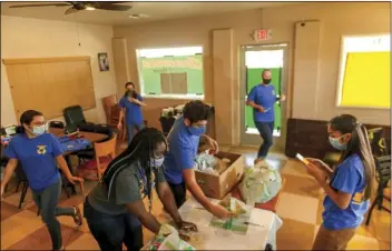  ?? PHOTO VINCENT OSUNA ?? FROM LEFT: Club members Bella Rebollar, Sharron Lee, co-advisor Angie Ibarra, club president Richard Torres, co-advisor Beth Carson and club member Julitza Alvarez work to fill bags during The Village’s bag-filling event on Thursday at Brownie’s Diner in Brawley.