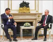  ?? SERGEI KARPUKHIN/SPUTNIK, KREMLIN POOL PHOTO VIA AP ?? Chinese President Xi Jinping speaks to Vladimir Putin at a public session of their meeting Monday in Moscow. Broader talks on a range of subjects are scheduled today.