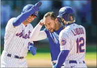  ?? John Minchillo / Associated Press ?? New York Mets’ Michael Conforto, center, celebrates after being hit by a pitch and scoring the winning run with the bases loaded during the ninth inning against the Miami Marlins on Thursday in New York.