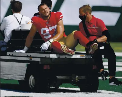  ?? BILL KOSTROUN — THE ASSOCIATED PRESS ?? 49ers defensive end Nick Bosa is carted off the field after suffering a possible torn ACL early in Sunday’s victory over the Jets.