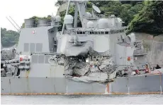  ?? AP ?? The damaged USS Fitzgerald is docked at the U.S. naval base in Yokosuka, southwest of Tokyo, after colliding with a Philippine-flagged container ship off Japan in June. Seven sailors on board died.
