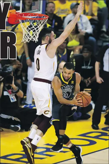  ?? — AP ?? Warriors’ Stephen Curry goes up for a shot against Cavaliers forward Kevin Love during Game 2 on Sunday. Curry made nine three-pointers in the Warriors’ victory.