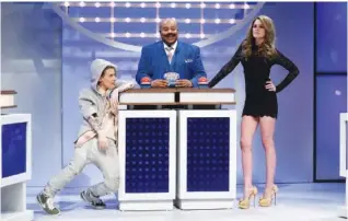  ?? NBC ?? “Saturday Night Live’s” Kenan Thompson, center, parodies Steve Harvey as host of “Celebrity Family Feud.”