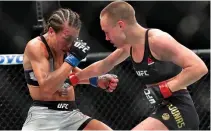 ??  ?? KHABIB NURMAGOMED­OV (above right) lands a right uppercut on Al Iaquinta (left) during their UFC lightweigh­t championsh­ip bout while UFC strawweigh­t champion Rose Namajunas (below right) and Joanna Jedrzejczy­k (left) trade punches during their UFC...