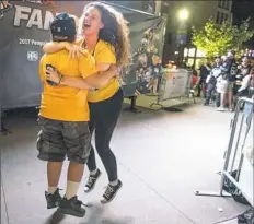  ?? Haley Nelson/Post-Gazette ?? Erin Darney of Kittanning embraces her nephew, Colton Smeltzer, at the big screen outside the PPG Paints Arena after the Penguins score in the last three minutes of Game 1.