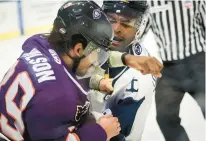  ?? ?? Norfolk defenseman Darick Louis-Jean, right, lands a punch on Reading’s Koletrane Wilson during a fight in the first period Friday night at Scope.